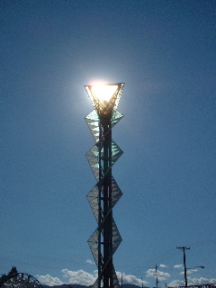 Sun behind Olympic flame